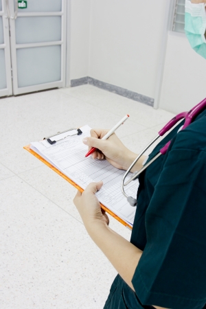 Doctor writing a prescribtion and medical examの写真素材