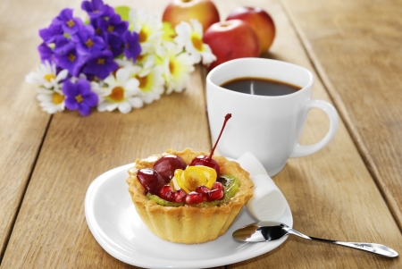 Hot coffee and tasty cake on the wooden tableの写真素材