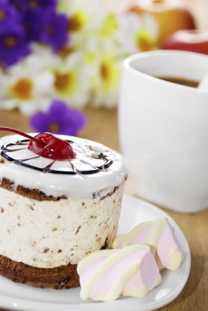 Hot coffee and tasty cake on the wooden tableの写真素材