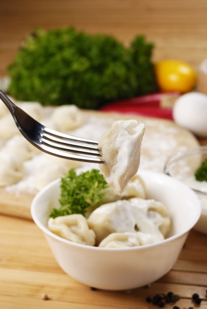 Fresh boiled meat dumplings served with sour creamの写真素材