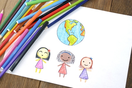 Children of different nationalities and Earth picture on the wooden tableの写真素材