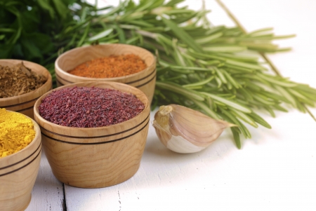 Different kinds of seasonings and herbs on the white oak tableの写真素材