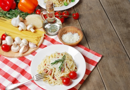 Pasta carbonara in the white plate on the wooden tableの写真素材