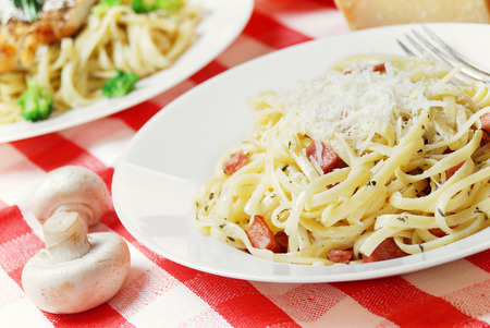 Pasta carbonara in the white plate on the wooden tableの写真素材