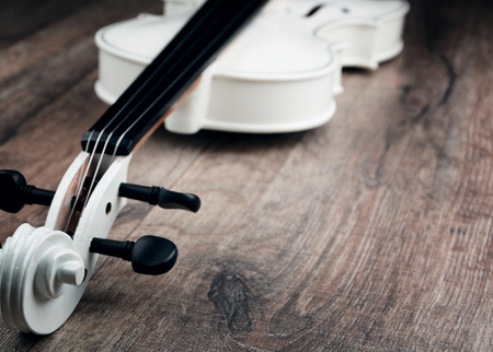 Beautiful white violin on the wooden tableの写真素材