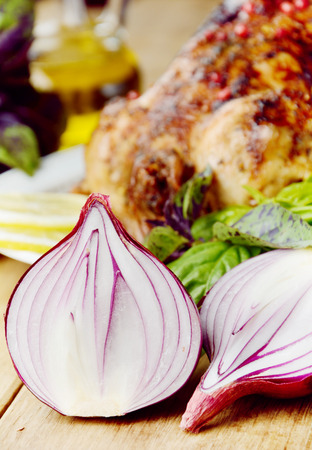Baked tasty hot chicken on the white plate with vegetablesの写真素材