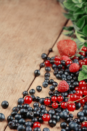 Bright summer frame of fresh sweet berries on the tableの写真素材