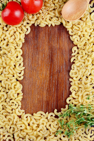 Raw Chifferi pasta background on the wooden tableの写真素材