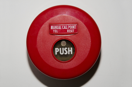 Red fire alarm on the wallの写真素材