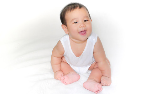 portrait of asian baby isolated on the bedの写真素材