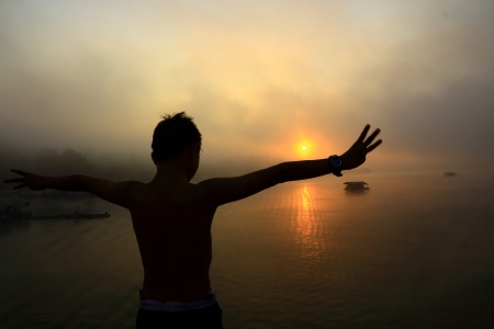 The young man on sunrise.の写真素材