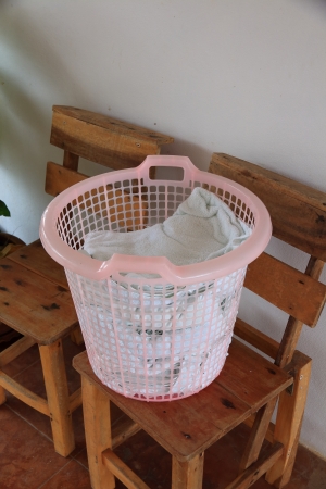 Clothes in White Plastic Basket の写真素材