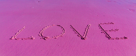 The Inscription on the Sand near the Sea - Pink LOVE の写真素材