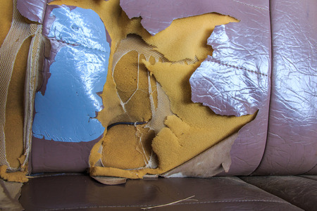 Old Car Seat with Torn Upholstery の写真素材
