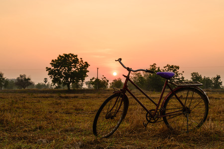 Vintage red bicycle with sunshine in morning.の写真素材