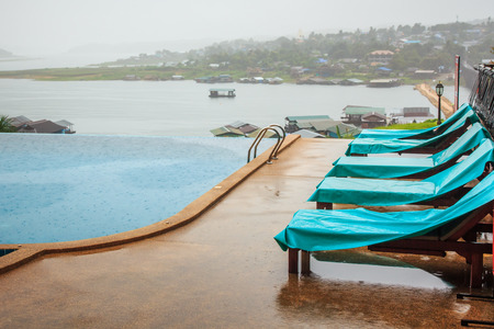Pool with Lounge in the Tropical Resort while Raining.