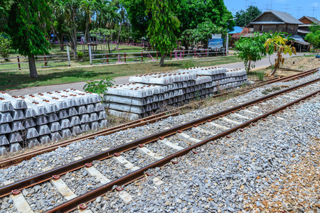 Stack of concrete railway sleepers near railroad.の写真素材
