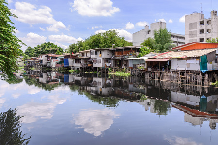 Urban ghetto house village canal side in Bangkok Thailand.の写真素材