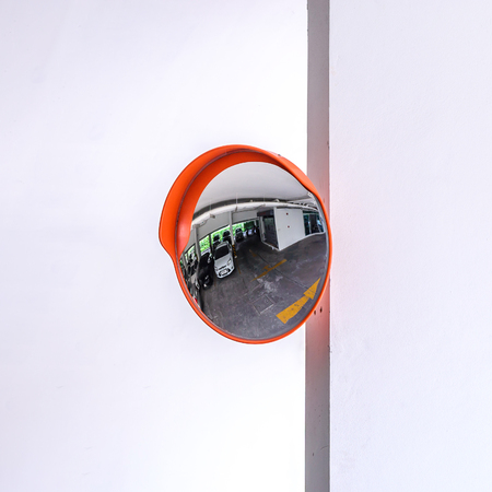 Traffic convex mirror at car park.