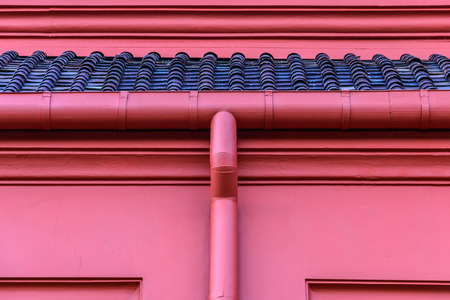 Metal roof gutter in red color.の写真素材
