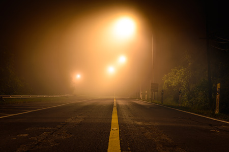 Country road with night light among the mist.の写真素材