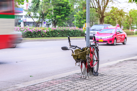 Broken bicycle locked with pillar in city.の写真素材