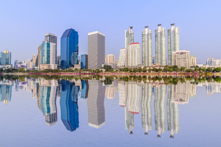Bangkok skyline and water reflection with urban lake in summer.の写真素材