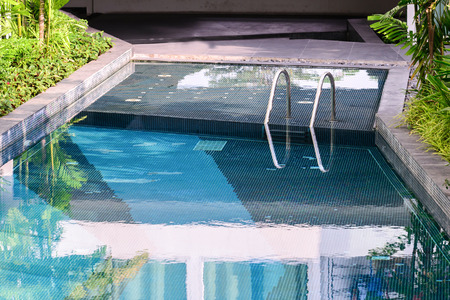 Swimmimg pool stair with sunny reflection.の写真素材