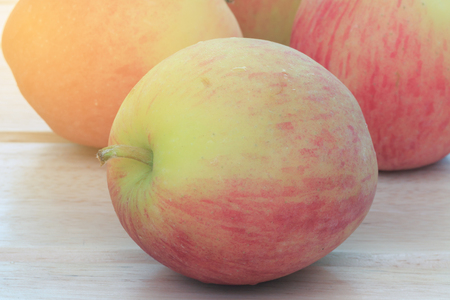 Apple on wooden table with natural lighting.の写真素材
