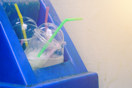 Overflow of drinking glass in trash can.の写真素材