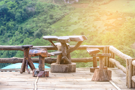Vintage wooden table on banboo balcony with mountain view.の写真素材