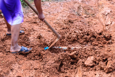 Simple underground pipe installation using hoe.の写真素材
