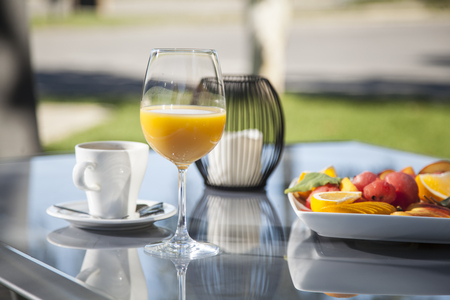 outside breakfast with fruit salad and orange juiceの写真素材