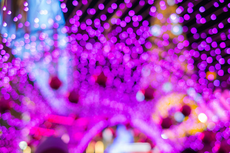Defocused light of christmas and new year festival, abstract pink bokeh with christmas background.