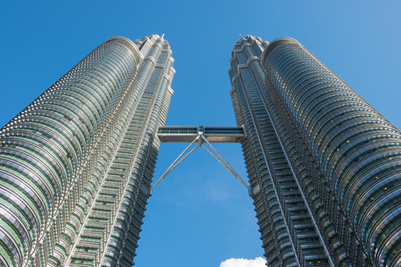 KUALA LUMPUR, MALAYSIA - FEBRUARY 29: Bottom view of Petronas twin towers on February 29, 2016 in Kuala Lumpur, Malaysia. The famous skyscraper with blue sky.のeditorial素材