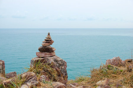 Zen concept, balance stone stack on the coastline with seascape background.