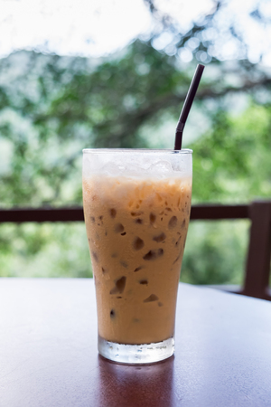 A glass of iced coffee on table in coffee shop with natural background.の写真素材
