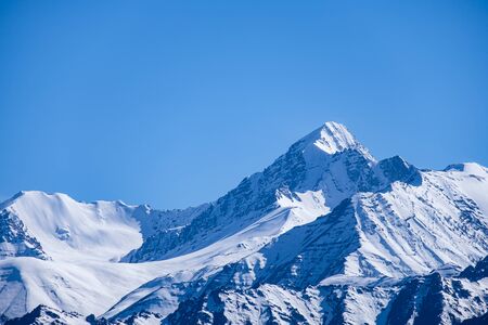 Snow covered mountains with blue sky from Namgyal Tsemo Gompa in Leh, Ladakh region, India.の写真素材