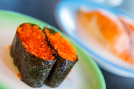 Sushi shrimp eggs with sushi salmon background の写真素材