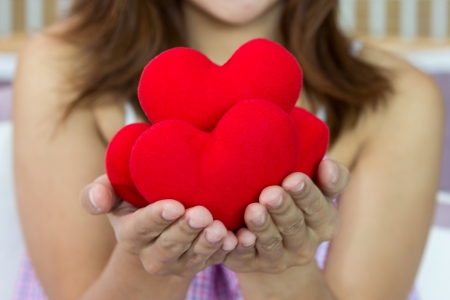 Closeup women happiness with many heart shape in hands の写真素材