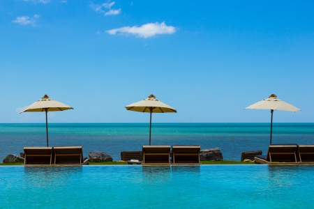 Three beach chairs on sea view in blue sky の写真素材