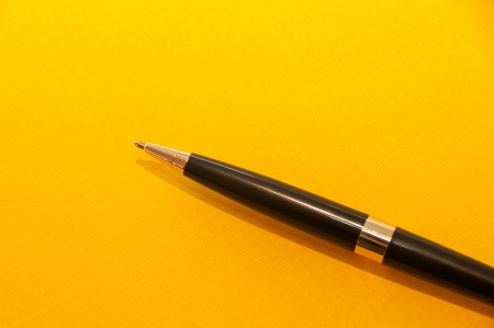 Luxury pen on yellow background の写真素材