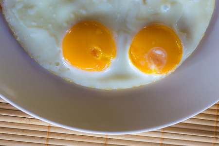 Top view fried eggs on dish の写真素材