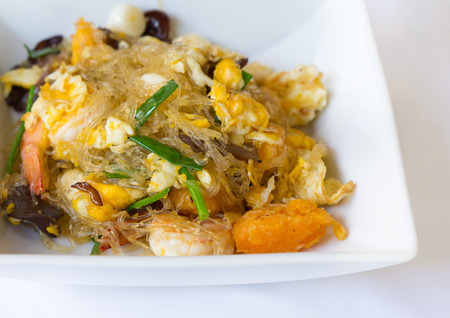 Vermicelli fried with vegetable, egg and shrimp on dish の写真素材