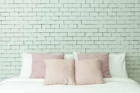 The bed on white bricks wall backgroundの写真素材