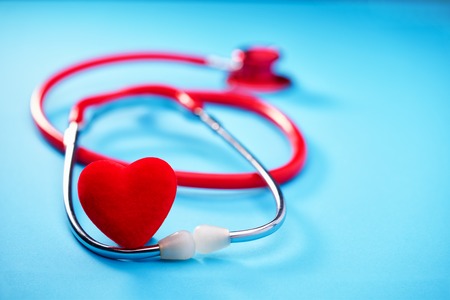 Heart and stethoscope on blue background.Medicine concept.の写真素材