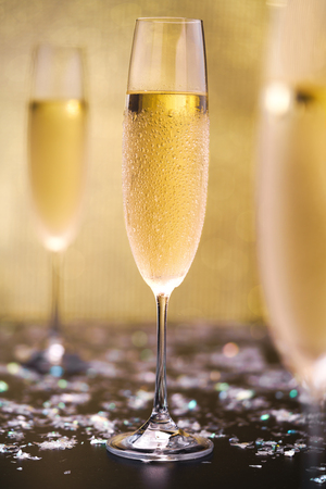 Cold champagne on gold background.Selective focus.の写真素材
