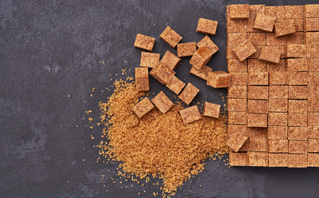 background of brown sugar cubes close-upの写真素材