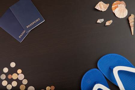 Passport, money, shells and Slippers are on the table.の写真素材