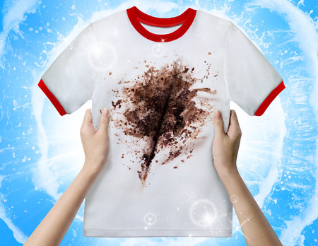 Hand holding dirty shirtの写真素材